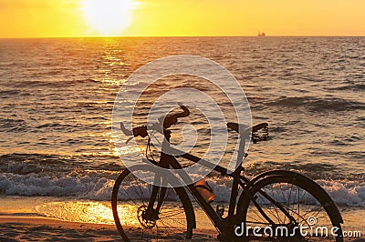 Sunset on the sea and Bicycle, Bicycle on the seashore Stock Photo