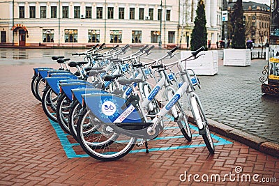 Bicycle-sharing system. Many blue shared bikes on street parking. Bicycle rental service spot on city street. Public Editorial Stock Photo
