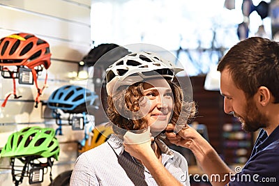 Bicycle shop consulting - customer tests a bicycle helmet for road safety Stock Photo