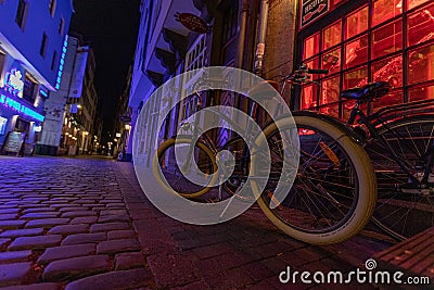 Bicycle stands near the wall of an old house in the old city of Europe Editorial Stock Photo