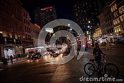 Bicycle, Traffic and a Streetcar on Canal Street in New Orleans Editorial Stock Photo