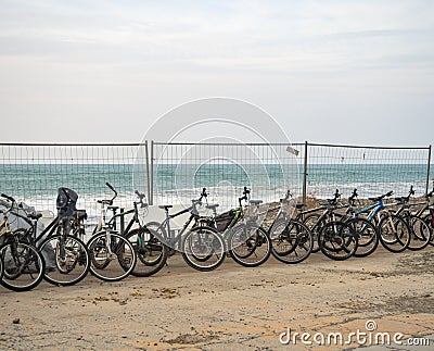 Bicycles for rent are located along the sea. Transport rental at the resort. Business on the beach. not a season Editorial Stock Photo