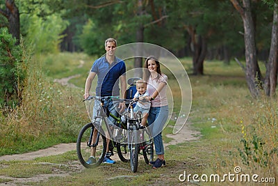 Bicyclist family, leisure in pine forest Stock Photo