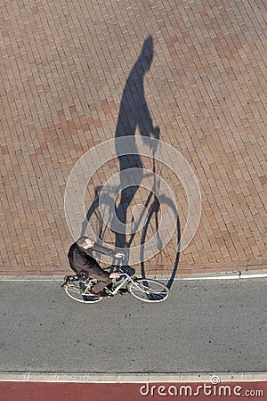 Bicyclist riding bicycle top view with shadow Editorial Stock Photo