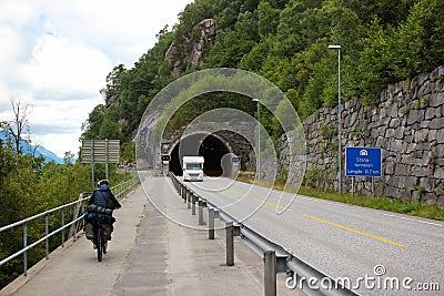 A bicyclist riding on a coastal road near Tyssedal, Norway Editorial Stock Photo