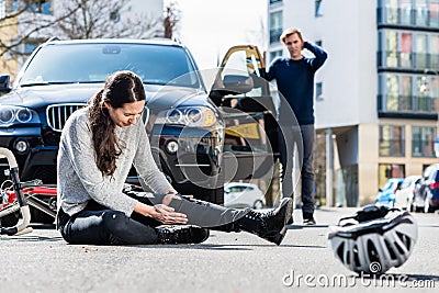 Bicyclist with serious injuries after traffic accident Stock Photo