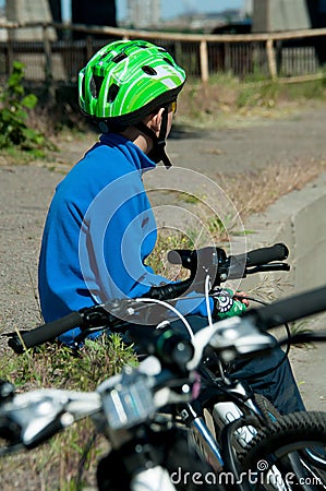 The bicyclist sits near the road Stock Photo