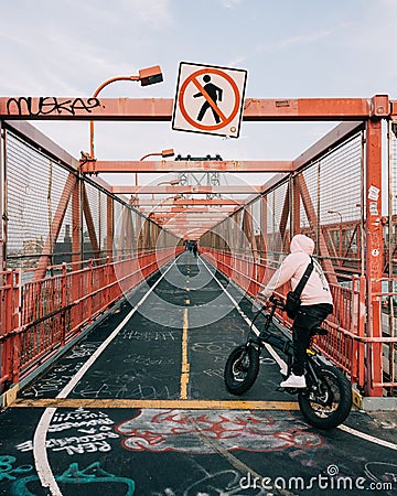 Bicyclist on the Williamsburg Bridge bike path, in Brooklyn, New York City Stock Photo