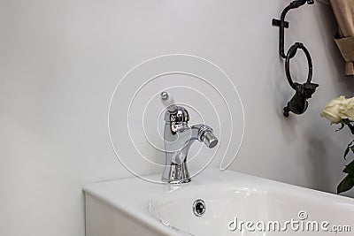 Bidet in modern toilet with wall mount shower attachment Stock Photo