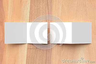 Bifold square brochure mock up on wooden background. 3D illustrating. Stock Photo
