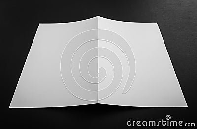 Bifold white template paper on black background . Stock Photo