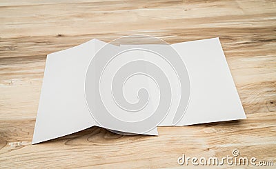 Bifold white template paper on wood texture. Stock Photo
