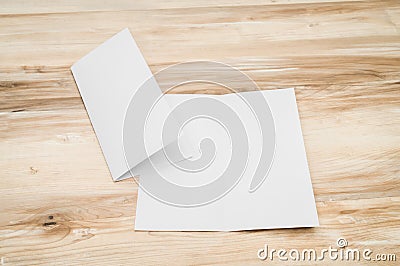 Bifold white template paper on wood Stock Photo