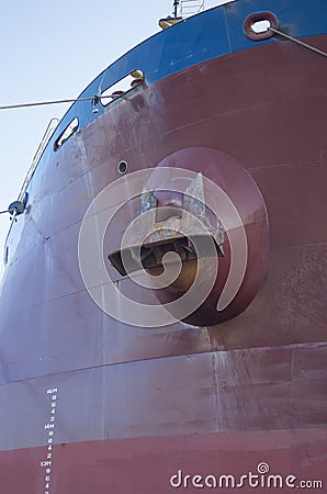 Big anchor on a cargo ship and scale for measuring the depth of draft Stock Photo