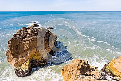 Big Atlantic ocean waves beat on rocks in Nazare, Portugal Stock Photo