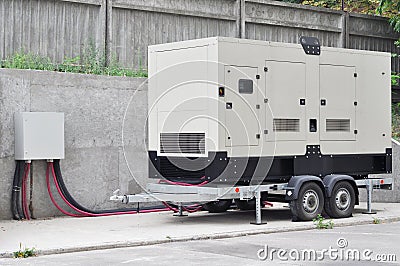 Big Backup Diesel Generator for Office Building Ð¡onnected to the the Control Panel with Cable Wire Stock Photo