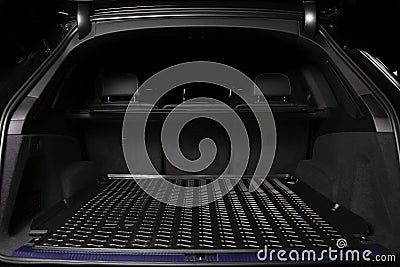 The big black empty trunk of SUV car with rubber mat and with le Stock Photo