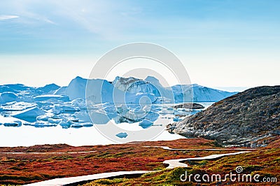 Big blue icebergs in the Ilulissat icefjord at sunset, Greenland Stock Photo