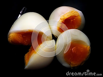 Medium boil egg cut to be half in black cup. Stock Photo