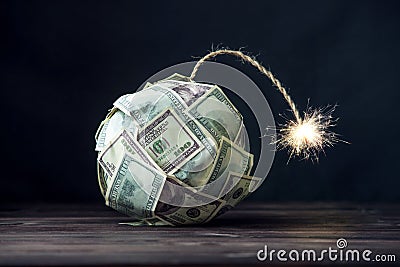 Bomb of money hundred dollar bills with a burning wick. Little time before the explosion. Concept of financial crisis Stock Photo