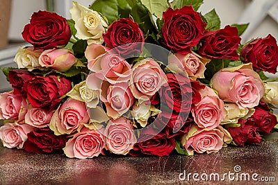 Big bouquet of multicolored roses, on table Stock Photo