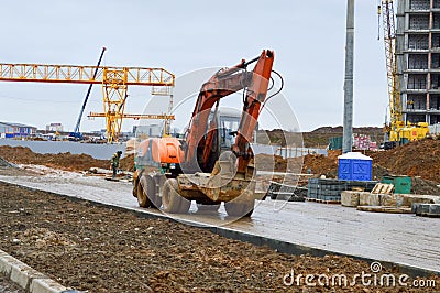 Big bright yellow powerful industrial heavy excavator tractor, bulldozer, specialized construction equipment for road repair Stock Photo