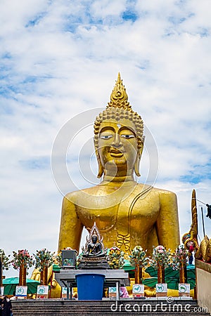 Big Buddha sculpture in temple with blue sky and clouds Stock Photo