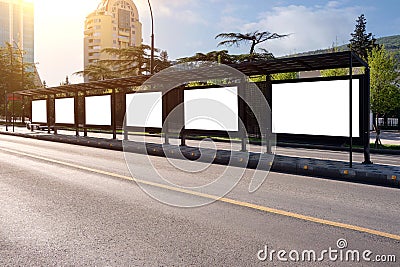 Big bus stop in a modern city with blank advertising banners inside Stock Photo