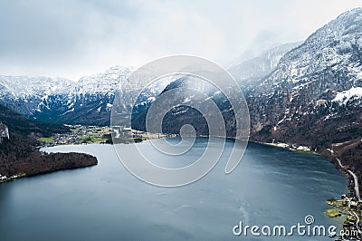 Big calm lake between the mountains covered with snow, under the Stock Photo