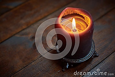 Big candle on wooden table Stock Photo