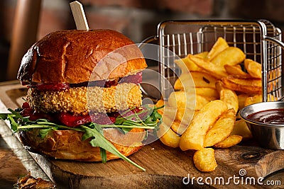 Big cheeseburger with french fries. Hamburger with beef patty onion, tomato, lettuce pickles, melted cheddar, mustards Stock Photo