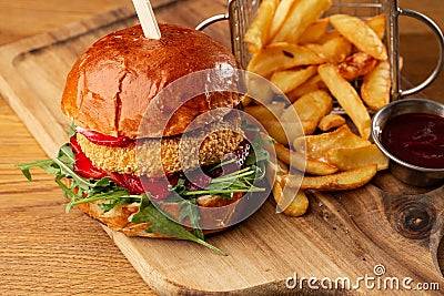 Big cheeseburger with french fries. Hamburger with beef patty onion, tomato, lettuce pickles, melted cheddar, mustards Stock Photo