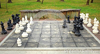 Big chess board with huge pieces in the park Editorial Stock Photo