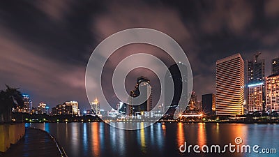 Big city in the night life with reflection of water wave. Long e Editorial Stock Photo
