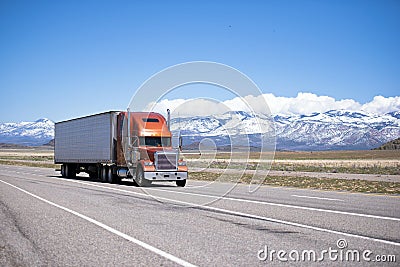 Big classic well maintained semi truck on high way Stock Photo