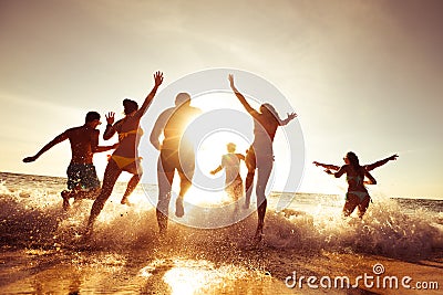 Big company of friends having fun at sunset beach Stock Photo