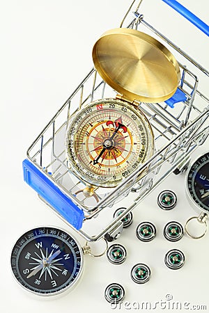 Big compass in cart and ten black compasses Stock Photo