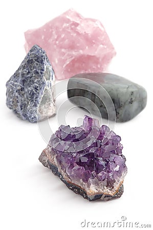 Four big different gemstones crystals on white background Stock Photo