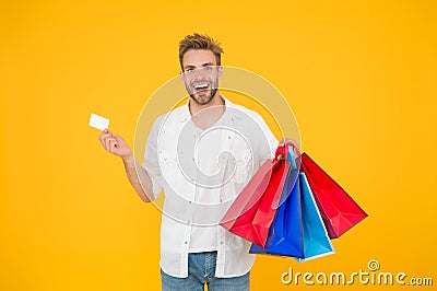 Big discount. Great choices great purchases. Happy man holding purchases in paper bags. Cheerful client customer Stock Photo