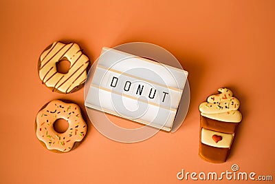 Big donut and Gingerbread coffee on orange background birthday decoration Stock Photo