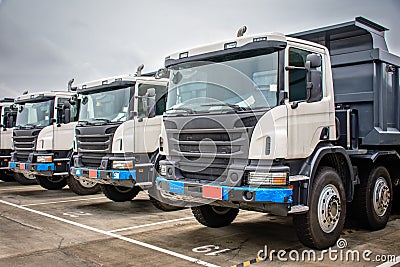 photo of brand new dump trucks, to use in construction site Editorial Stock Photo