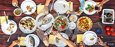 Big family dinner in process. Top view vertical image on table w Stock Photo