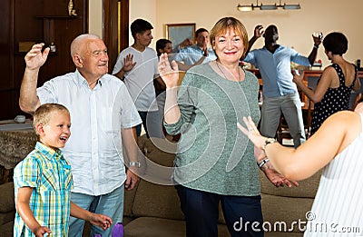 Big family dancing in living room Stock Photo