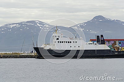 Big ferry ship on tromso port with snow mountains Editorial Stock Photo