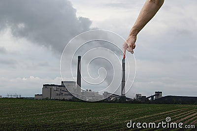 A Big Finger Plugging a Smoke Stack Stock Photo