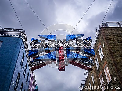 Big flashing sign signifying the entrance to street of Carnaby Editorial Stock Photo