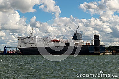 Big freighter or cruise ship loading at the harbor. Industrial container ship at terminal. Exporting products on a global scale Stock Photo