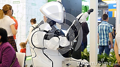 Big funny robot with big blue eyes smiling and talking, showing emotions, modern technologies concept. Media. Face Editorial Stock Photo