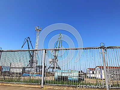 Big gate near the port of seaside. Sunny day in the city Stock Photo