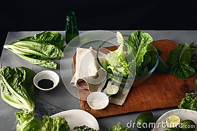 Big glass bowl green salad romaine lettuce ingredients cooking d Stock Photo